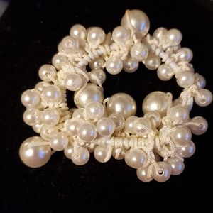 Faux pearl stretch bracelet with multiple pearls grouped around an elastic band